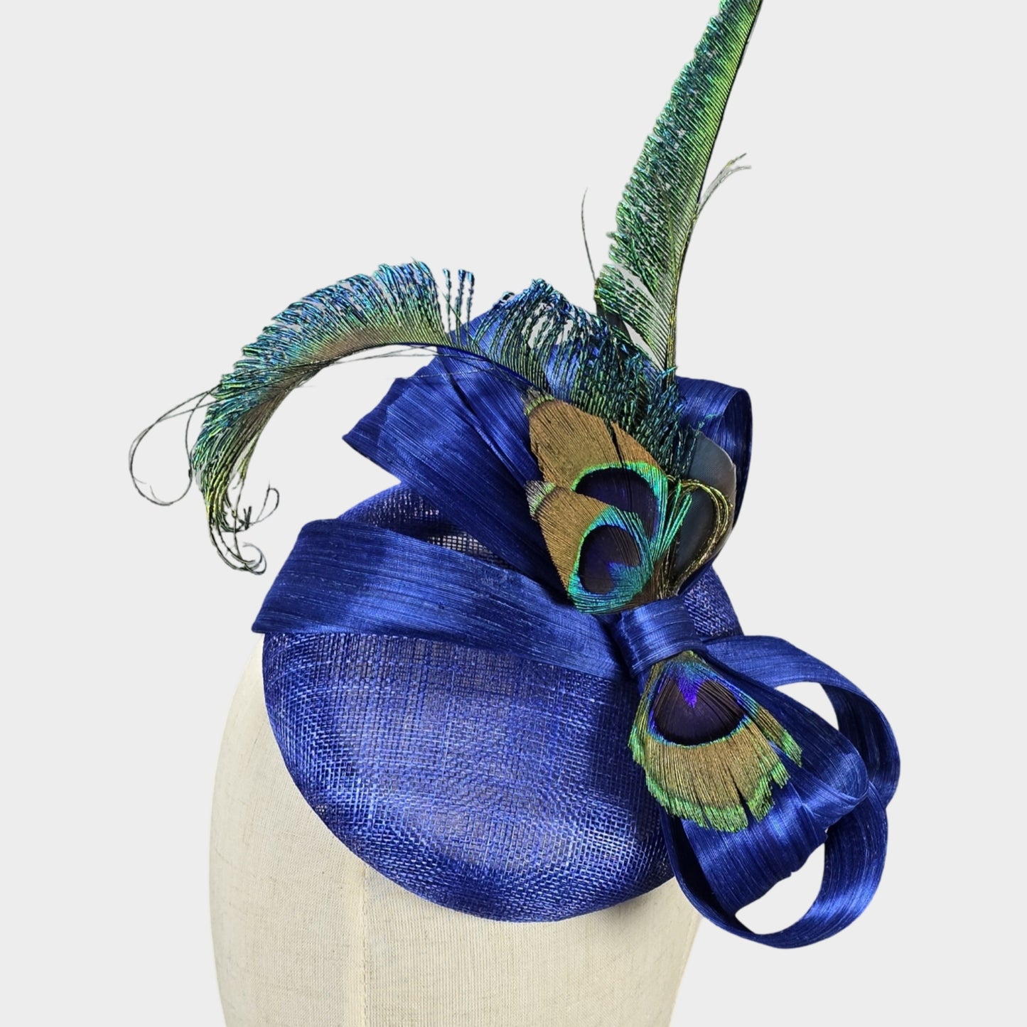 Royal blue sinamay pillbox hat with peacock feathers