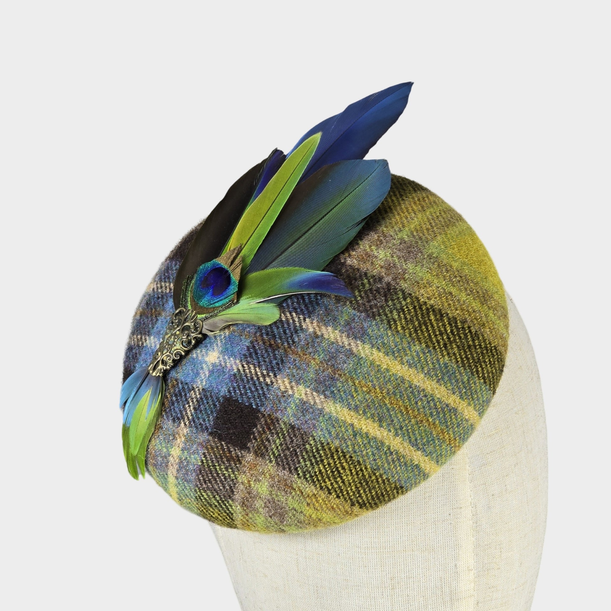 Plaid wool pillbox hat with parrot feathers