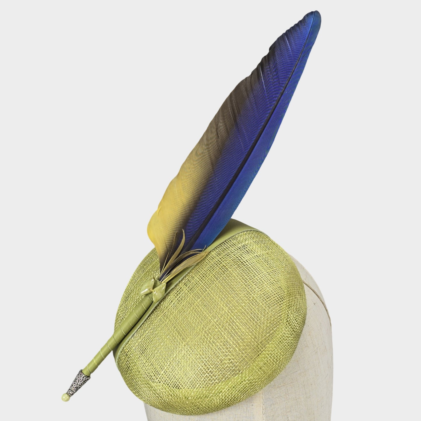 Chartreuse sinamay pillbox hat with blue Macaw feather