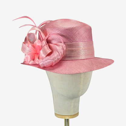 Pink straw hat with silk abaca trim on a mannequin head against a white background