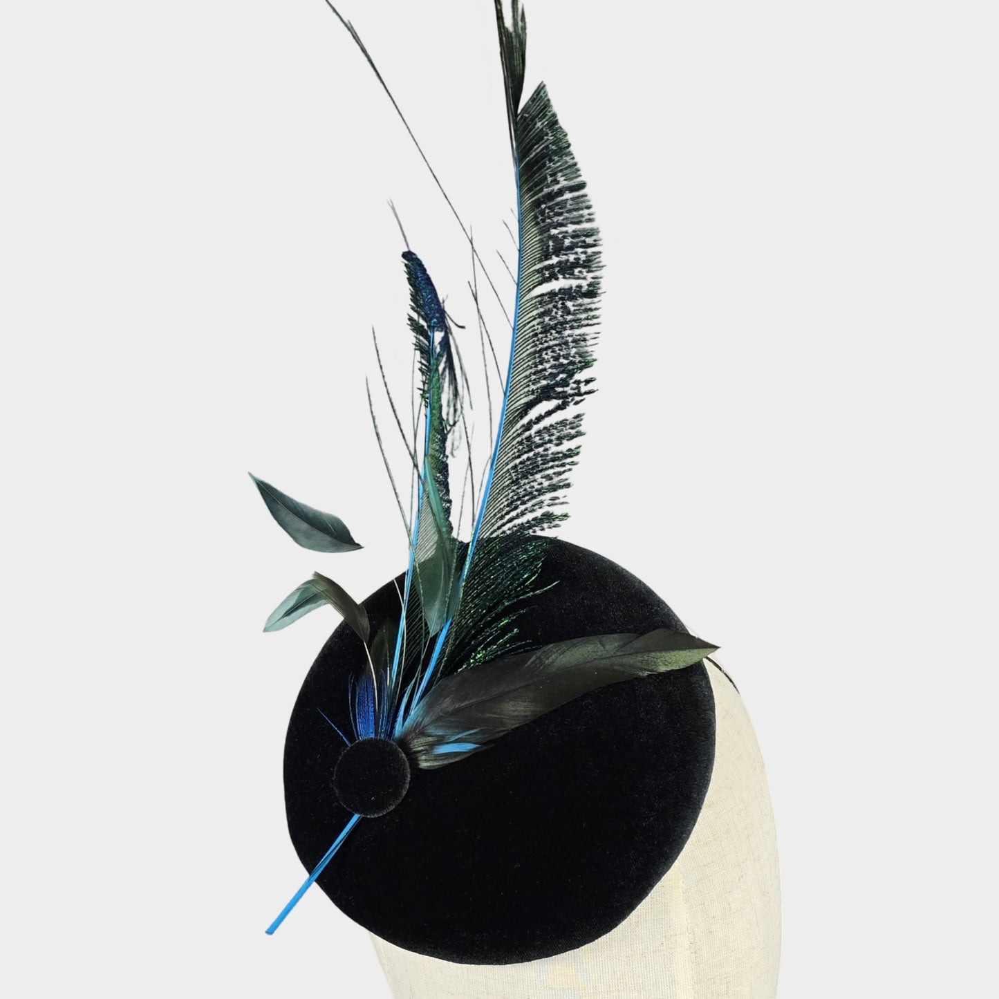 Dark green velvet pillbox hat with peacock feathers