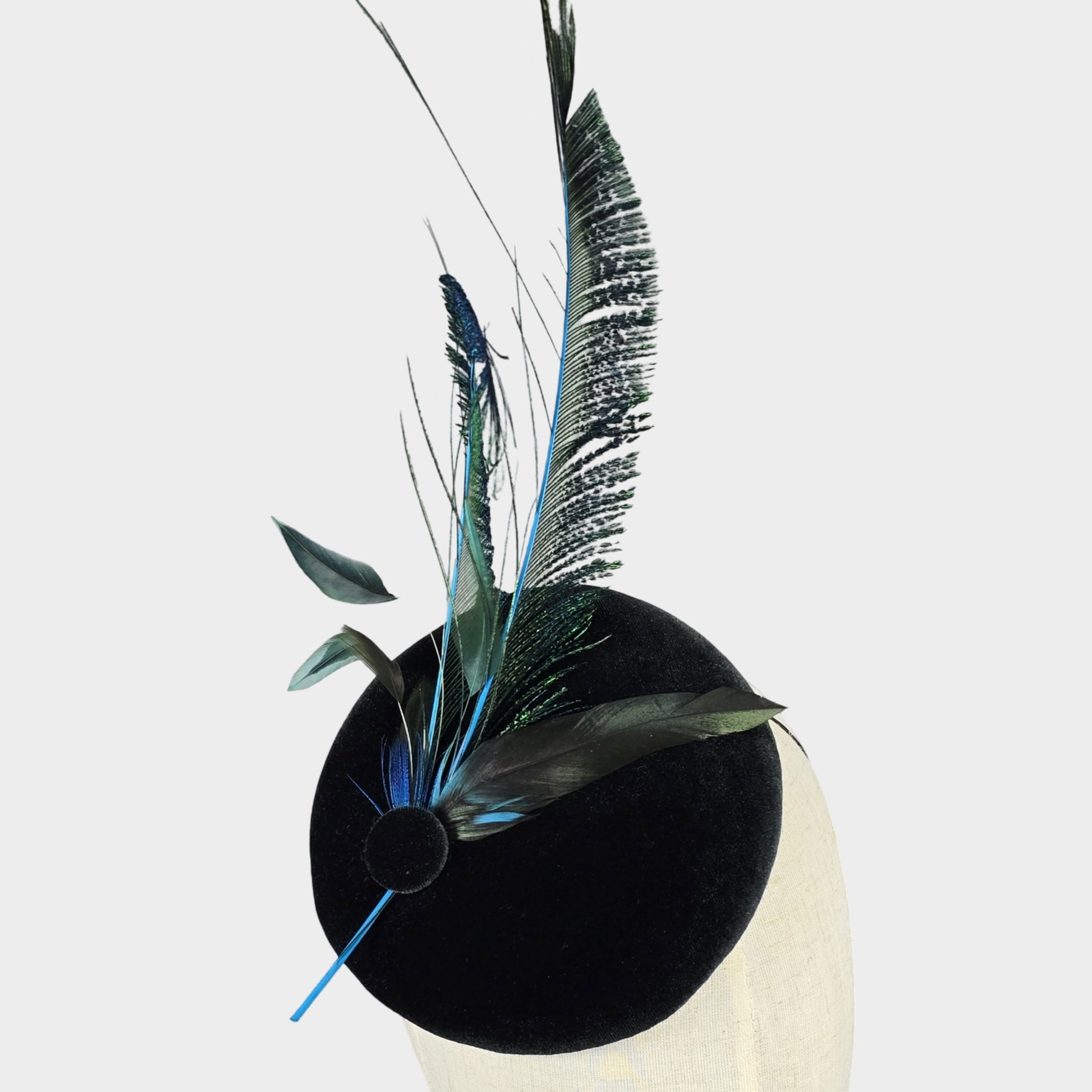 Dark green velvet pillbox hat with peacock feathers