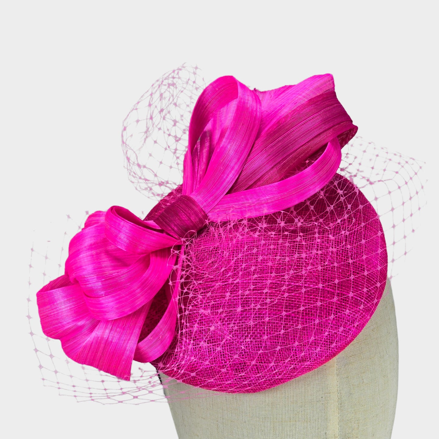 Hot pink sinamay pillbox hat with abaca silk bow