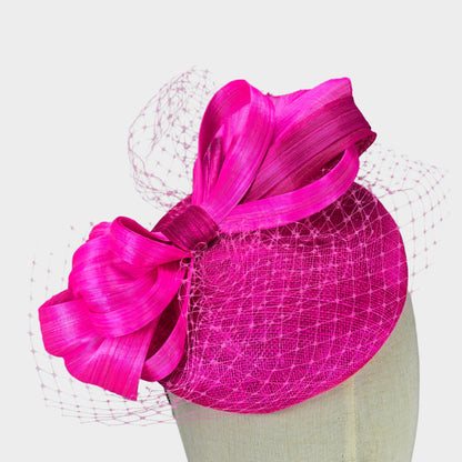 Hot pink sinamay pillbox hat with abaca silk bow