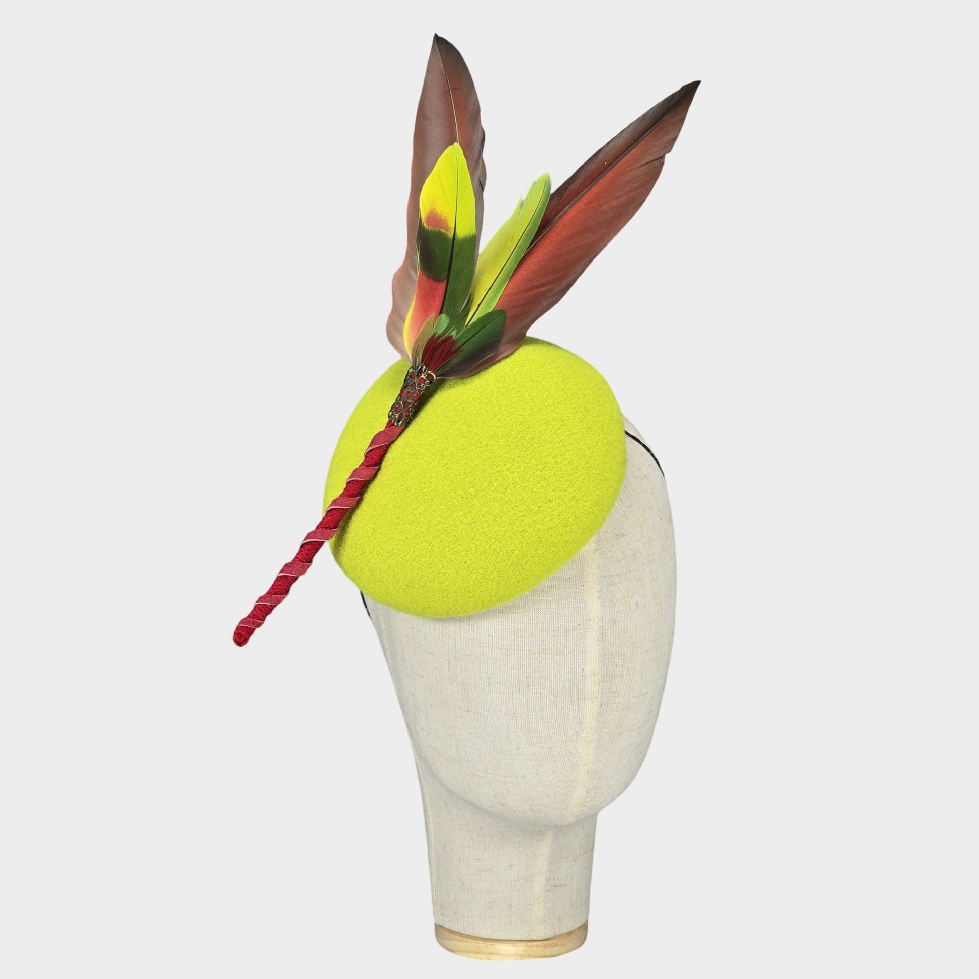 Neon green pillbox hat with parrots feathers