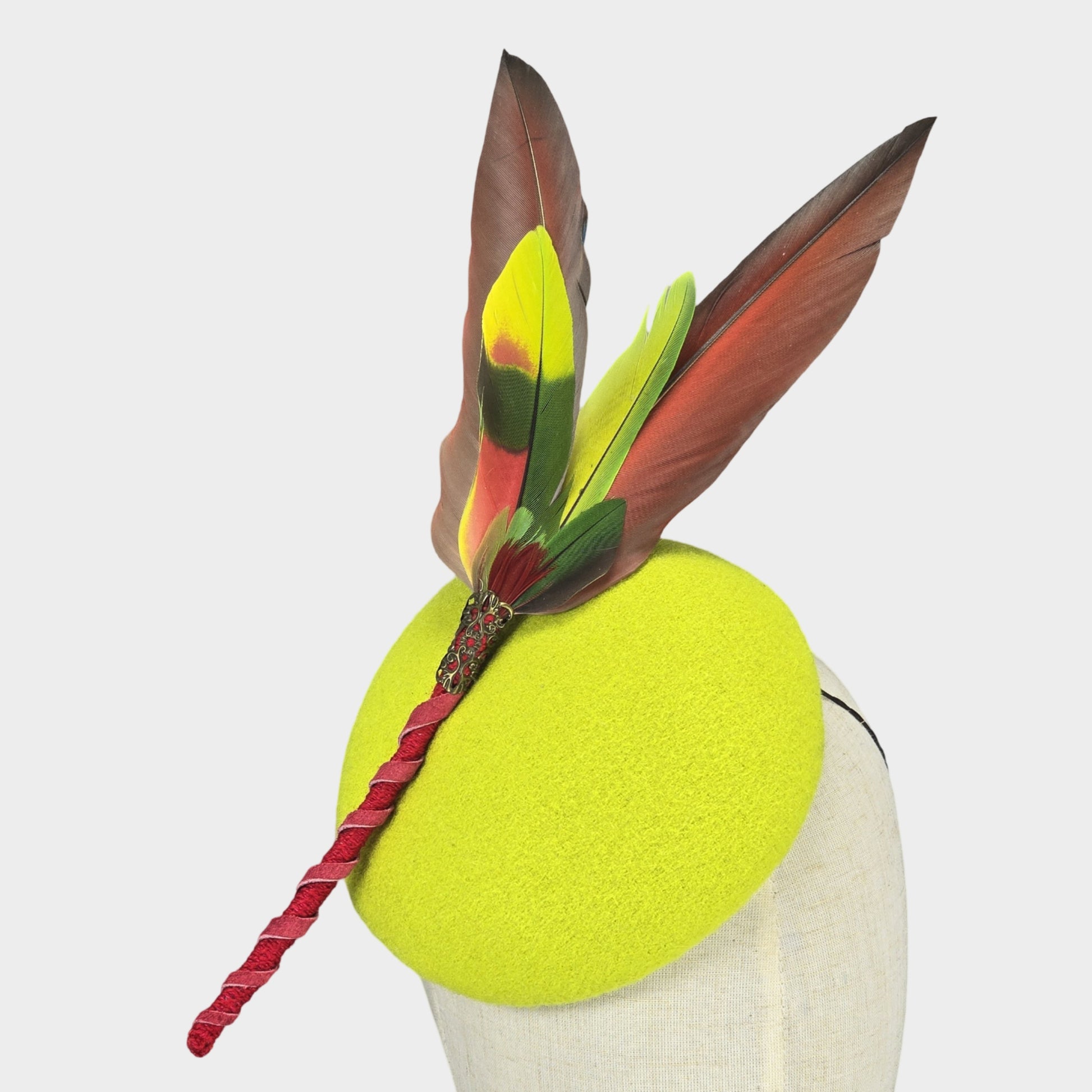 Neon green pillbox hat with red Macaw and Amazon feathers