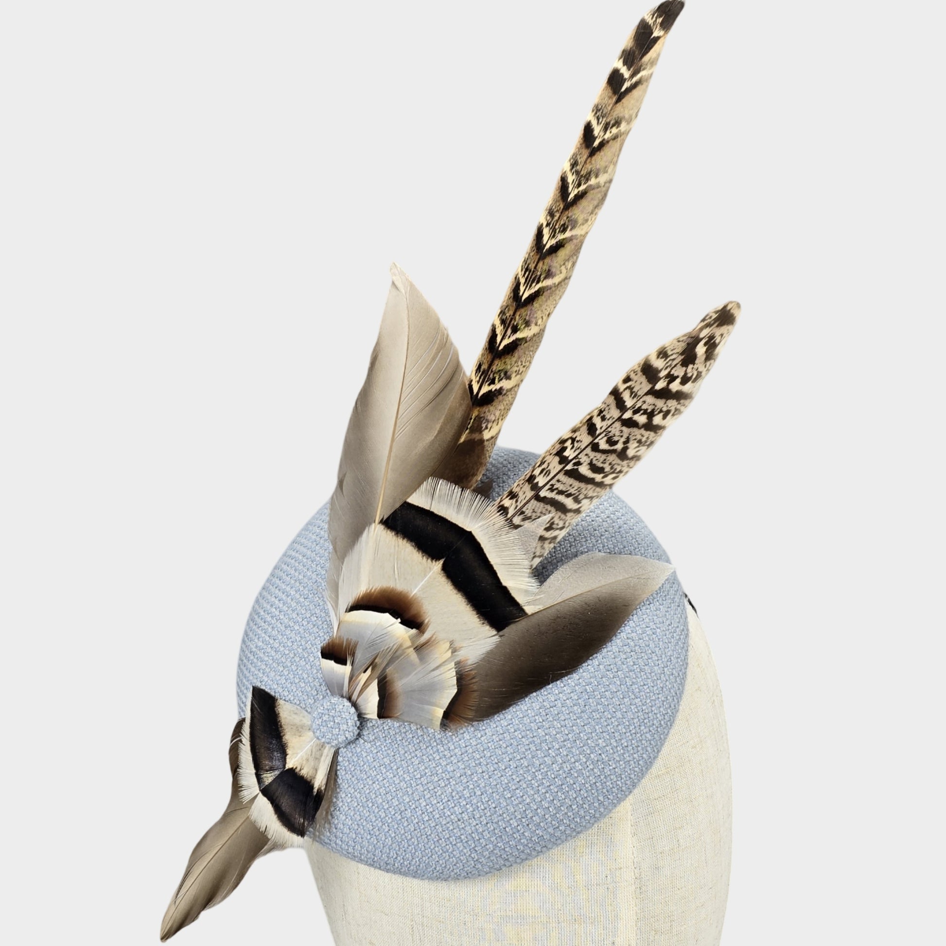 Pale blue pillbox hat with pheasant feathers