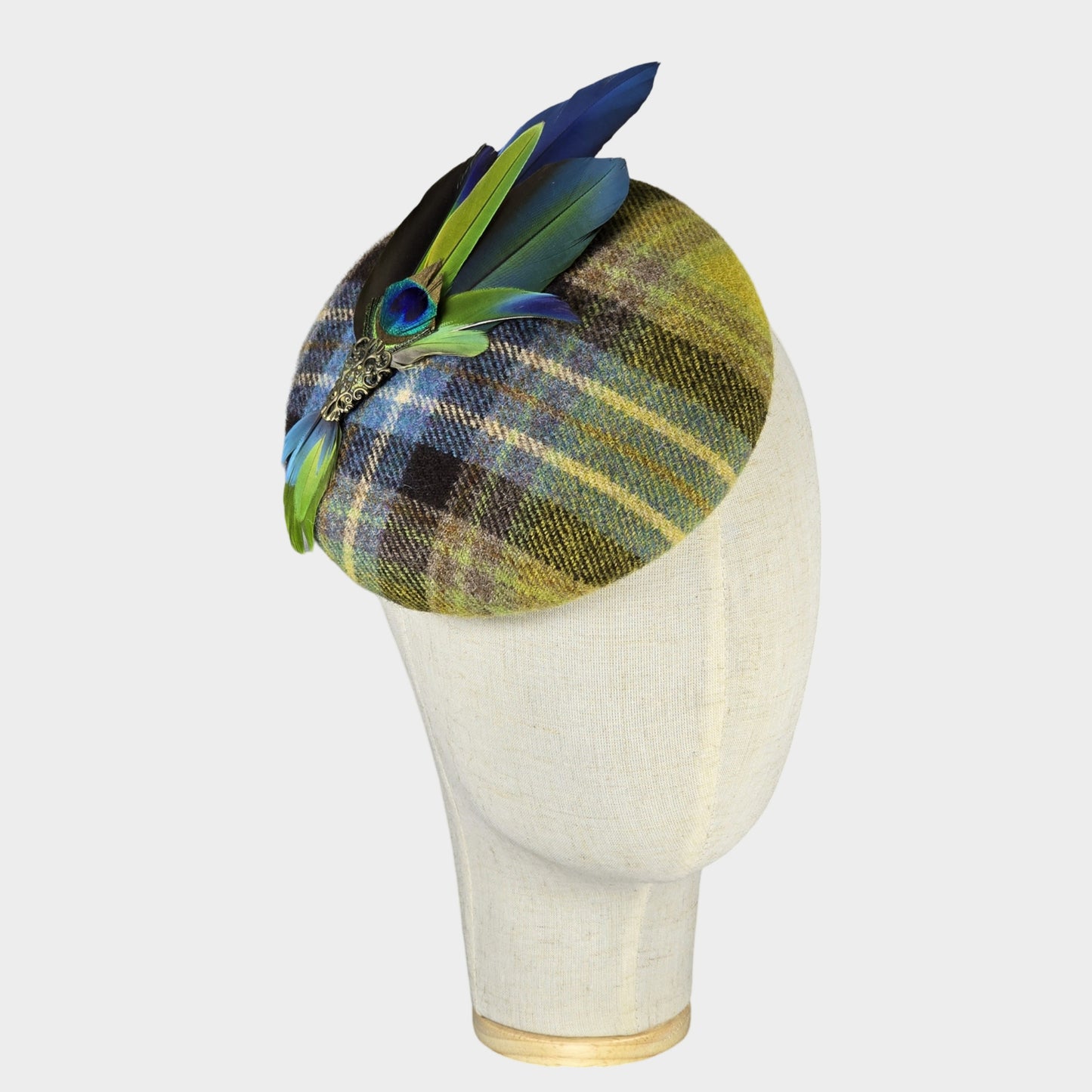 green blue wool pillbox hat with parrot feathers
