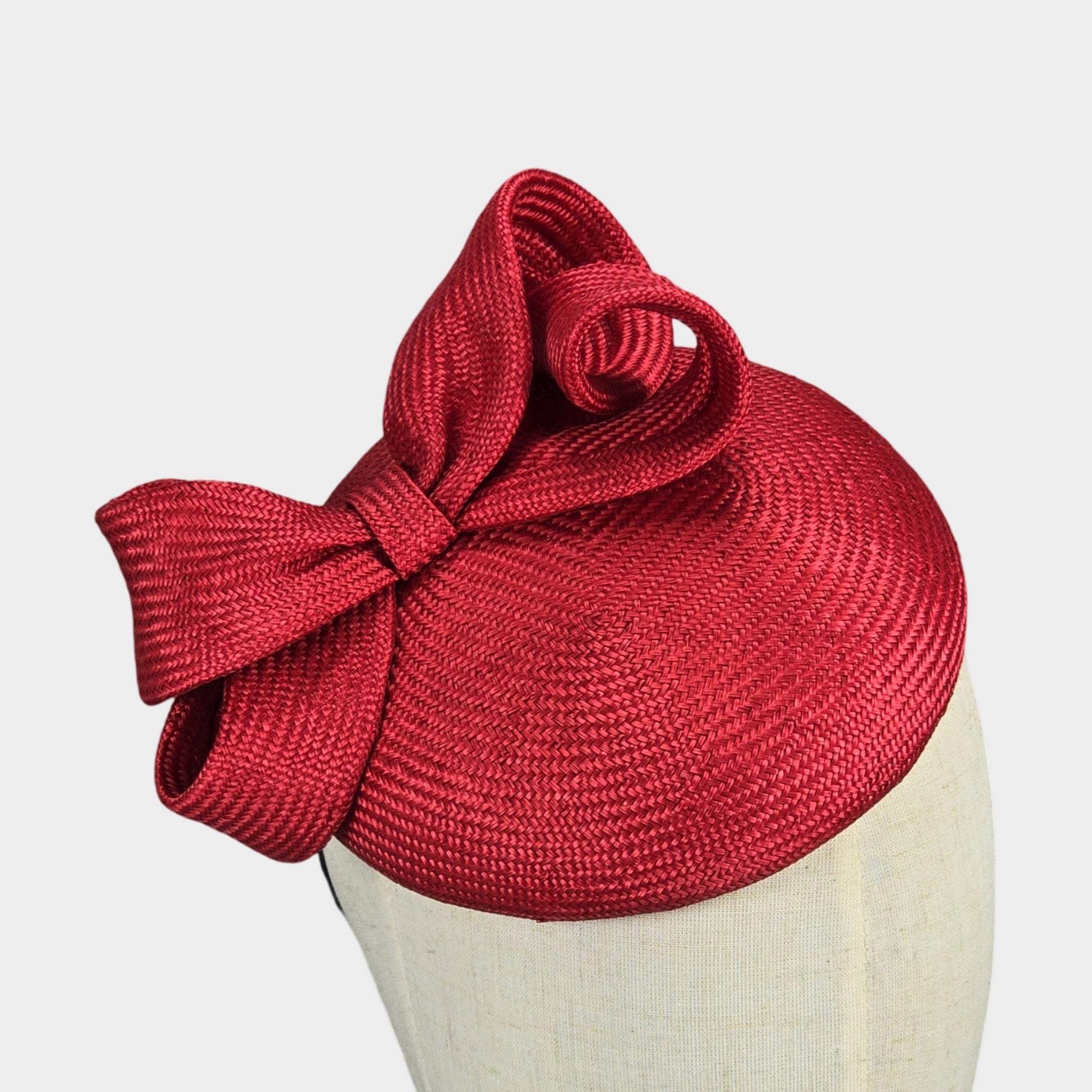 Red straw pillbox hat with sculpted bow Liskin Millinery