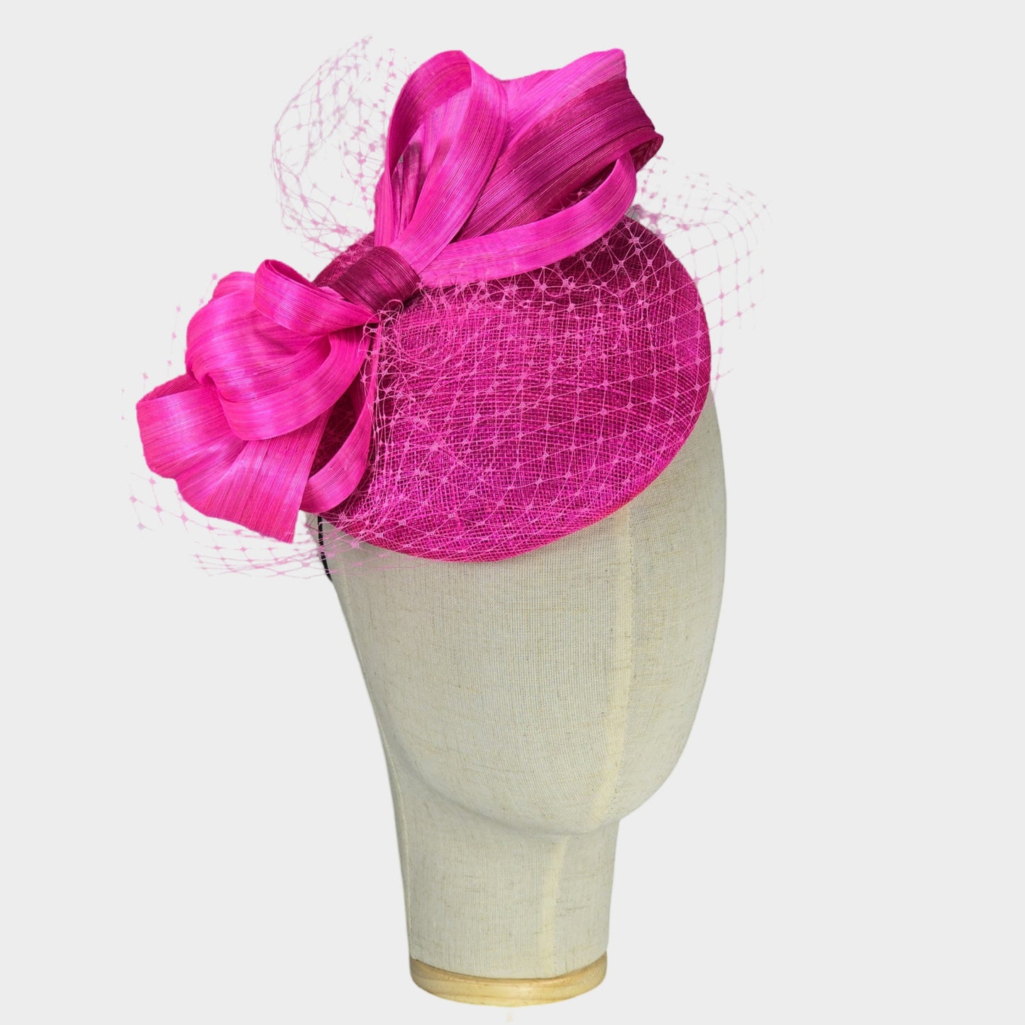Hot pink sinamay pillbox hat with abaca silk bow