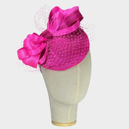 Hot pink sinamay pillbox hat with abaca silk bow