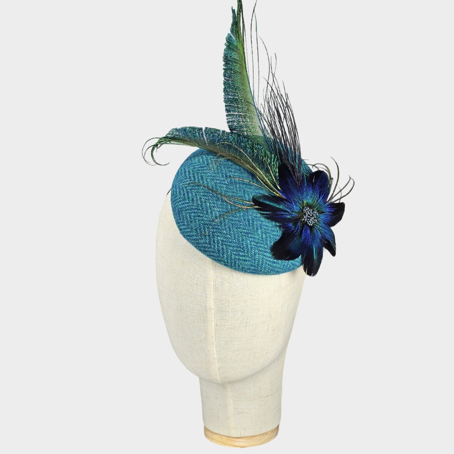 Turquoise tweed pillbox hat with feather flower