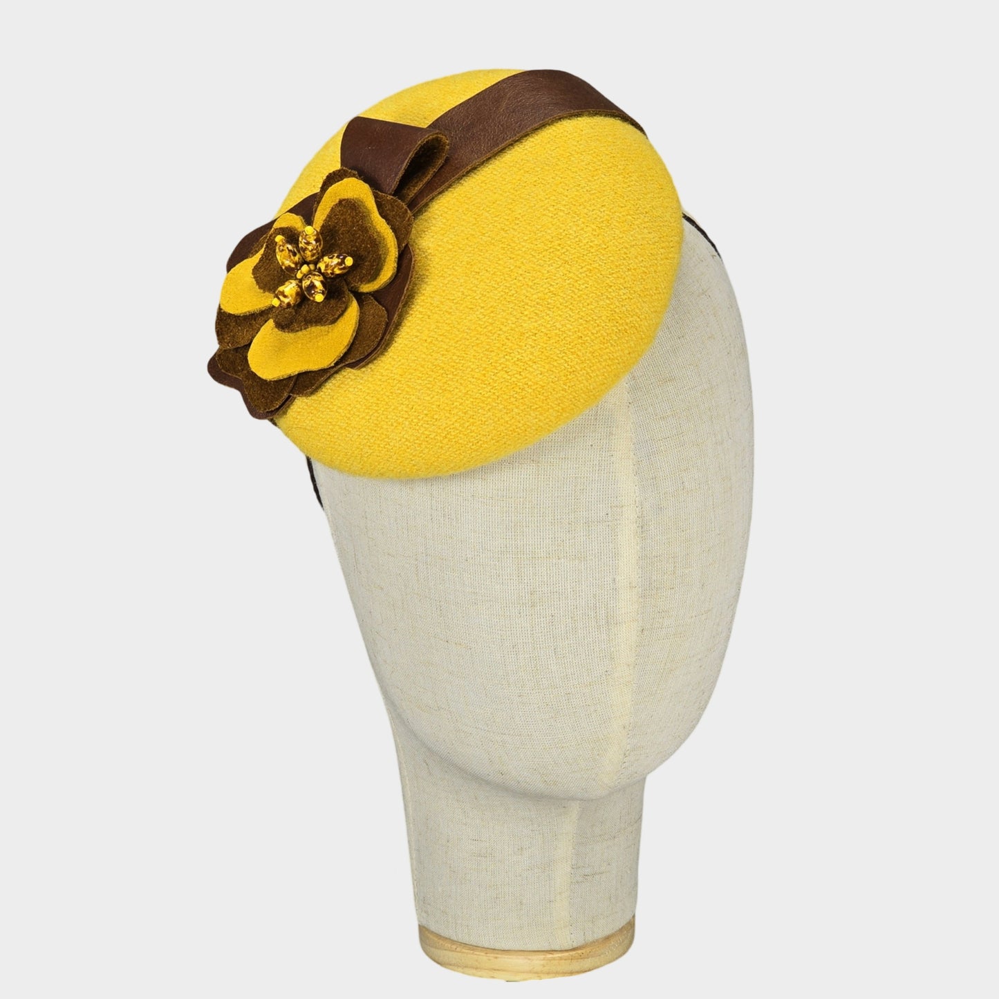 yellow pillbox hat with brown leather flower