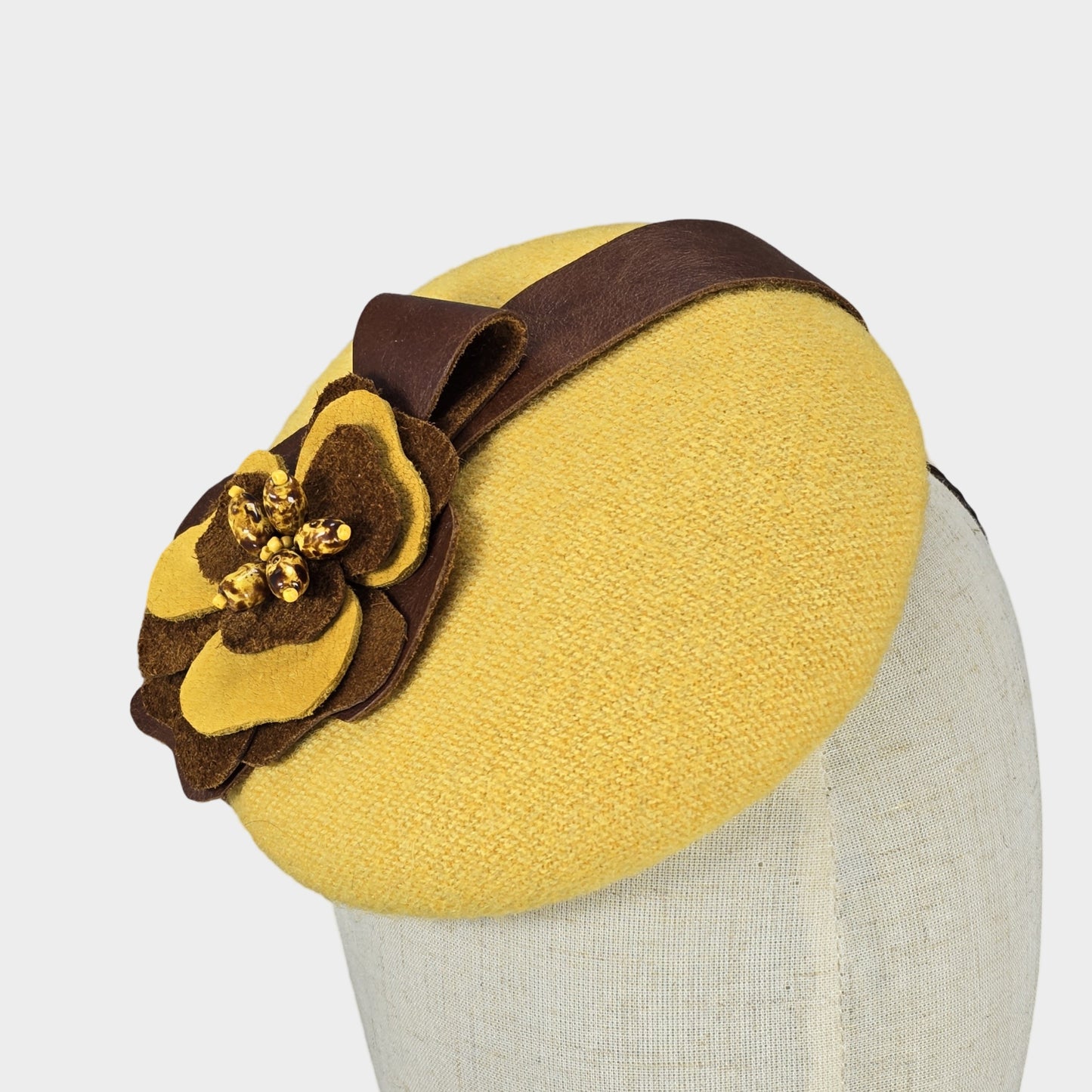 yellow pillbox hat with brown leather flower  Liskin Millinery Studio